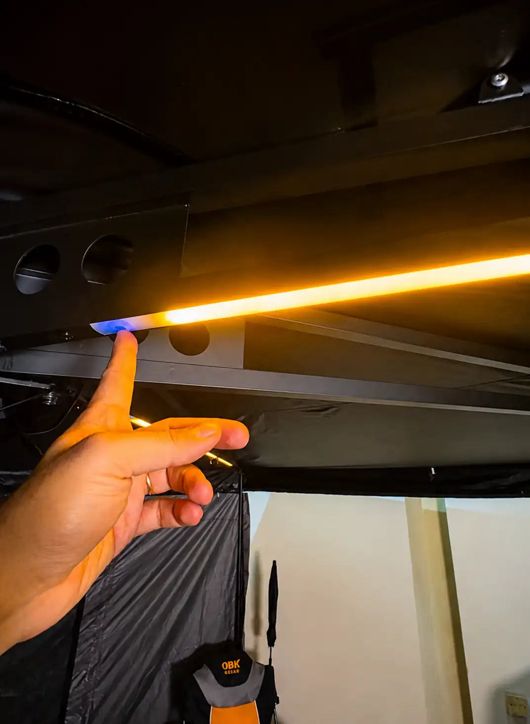 OBK awning tri-color touch LED light with integrated touch control, offering warm, white, and mixed lighting modes for convenient campsite illumination.