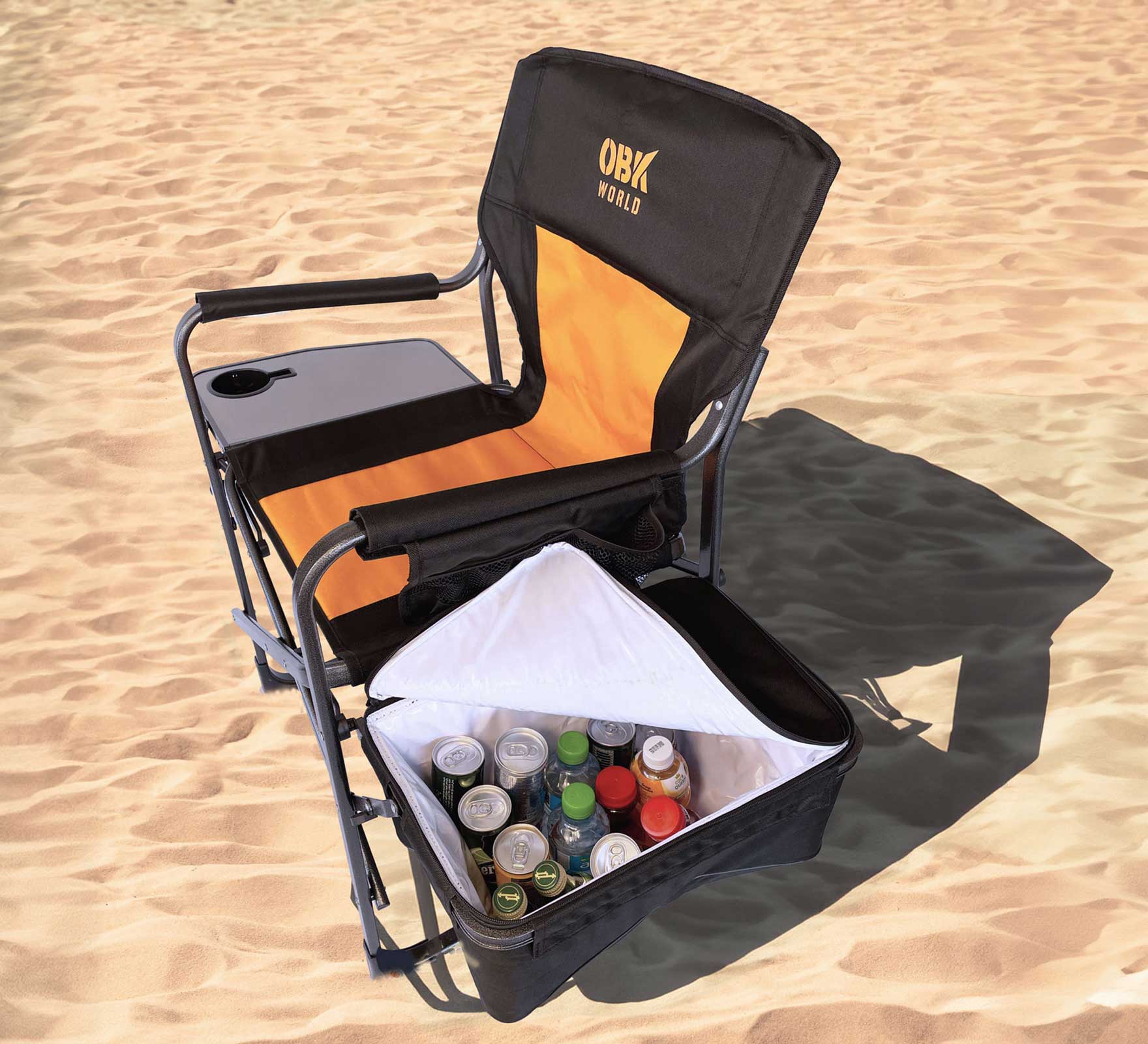 Folding chair with cooler on sand, featuring OBK World branding.